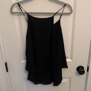 Black spaghetti straps tank top. Subtle ruffles at the bottom.